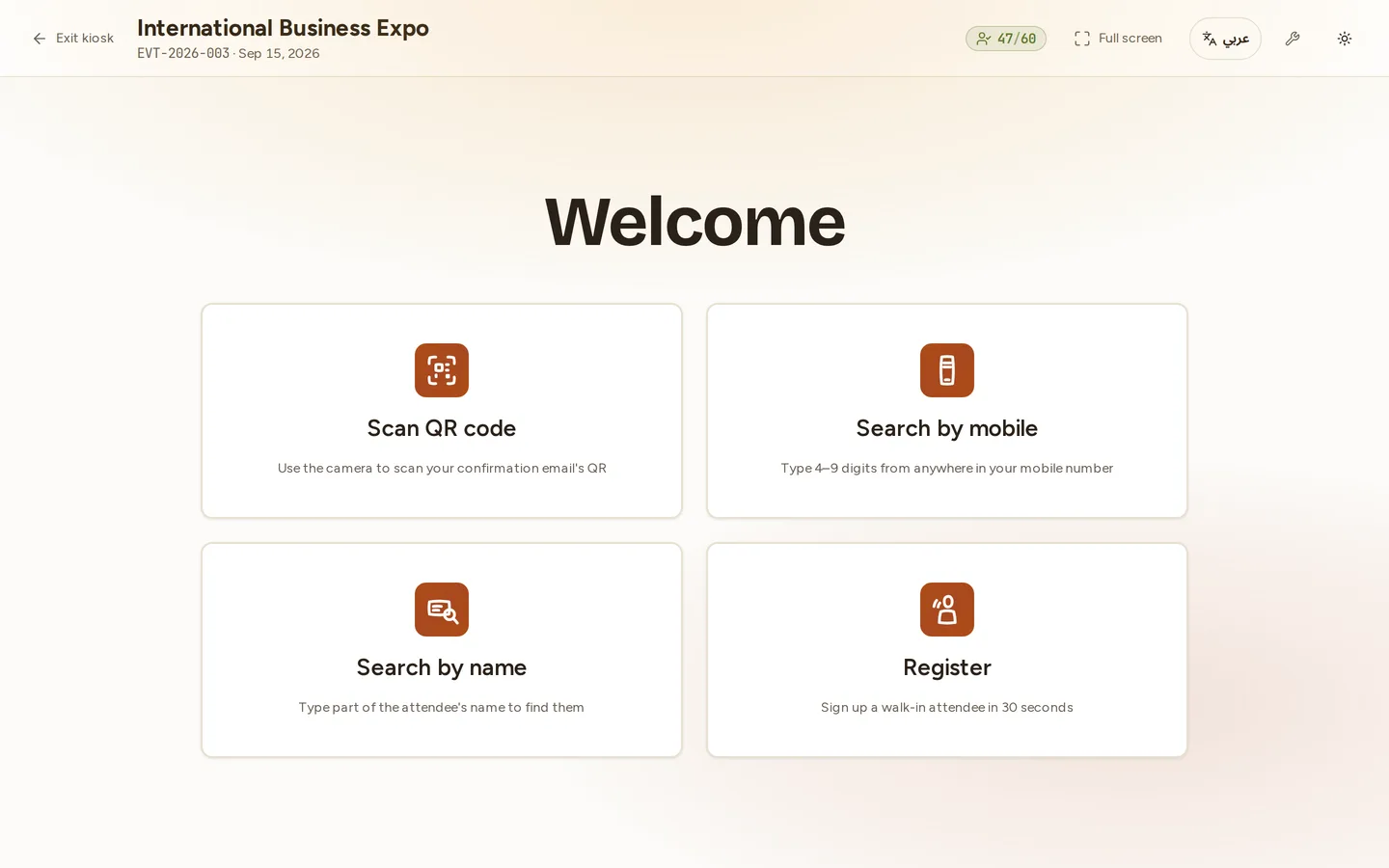 The kiosk welcome screen in fullscreen: the event name and code in the header with a live checked-in counter and an Arabic language switch, and four large cards — Scan QR code, Search by mobile, Search by name and Register.