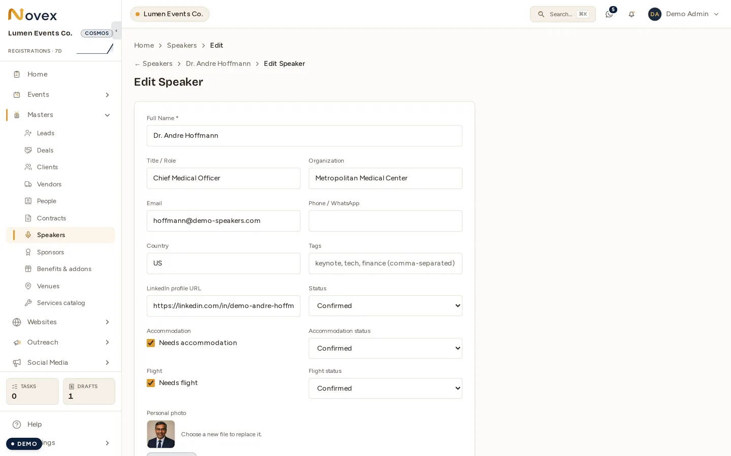 A speaker's edit form with both gates switched on: the Needs accommodation and Needs flight checkboxes ticked, each beside its own status dropdown set to Confirmed, above the name, title, organisation, country and status fields.